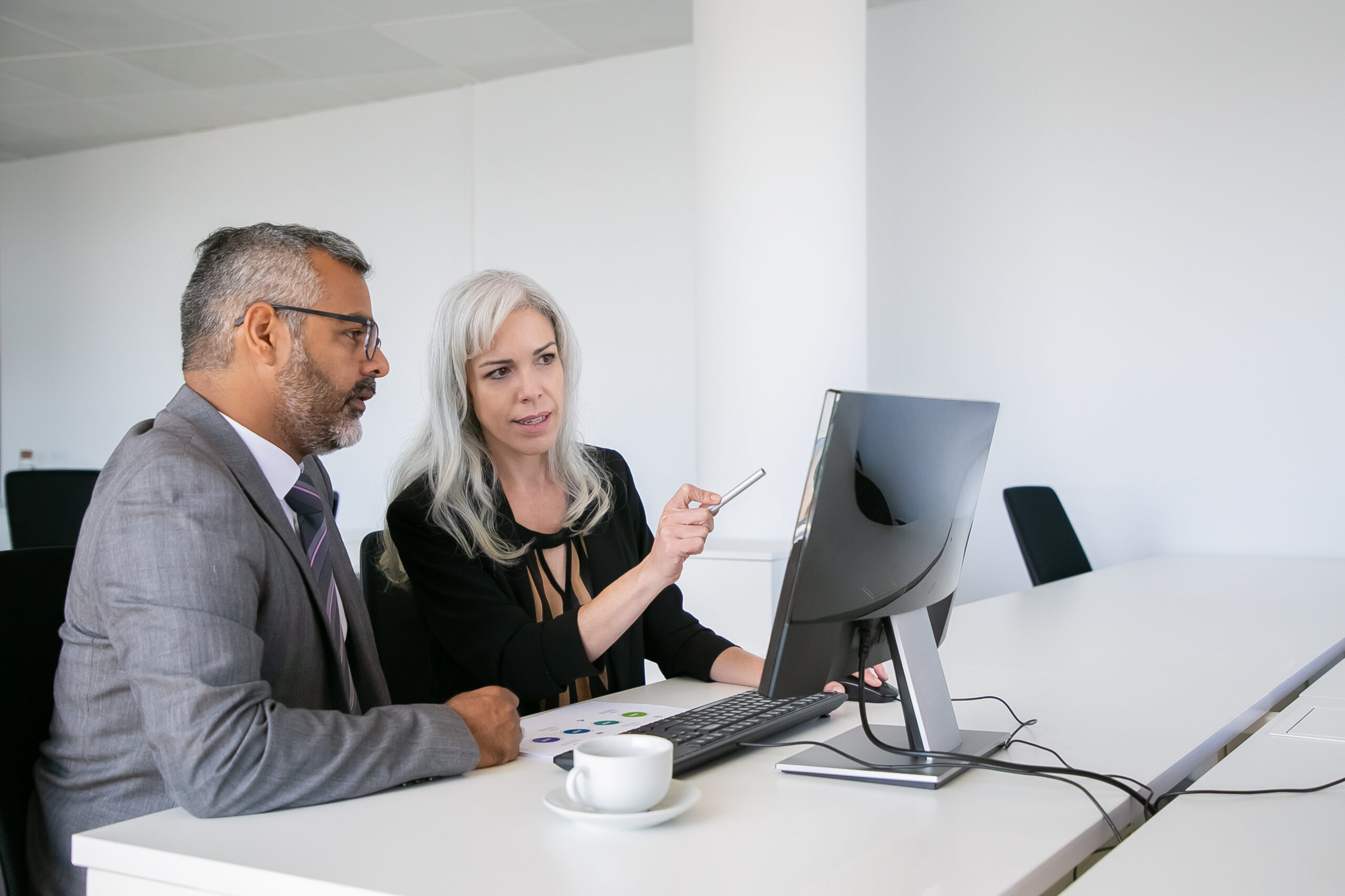 Focused business colleagues watching content on computer